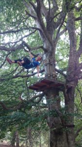 Maïa suspendue à un arbre au parc accrobranche du rondin des bois